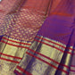 Detailed plum-red and purple contrast border with ornamental kodi butta work and gold zari bands.