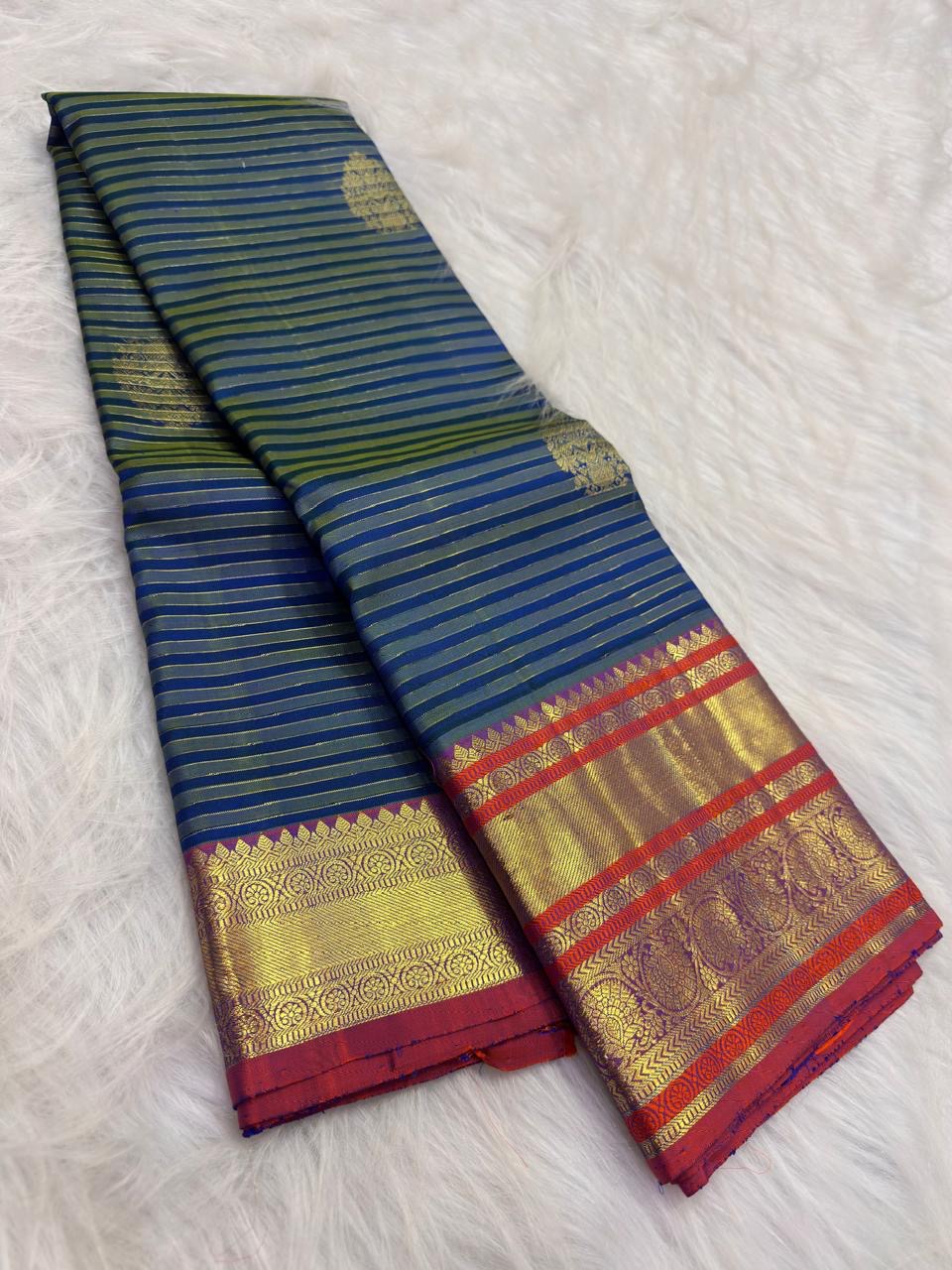 Blue Vairaoosi pure silk Kanchipuram saree with fine zari stripes, decorative buttas and contrast border.
