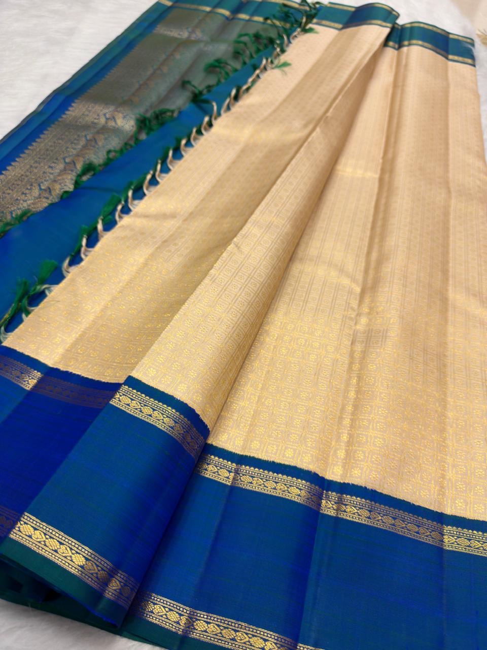 Warm Ivory Handwoven Pure Silk Kanjivaram Saree with Zari Kattam and Peacock Blue-Green Shot Border