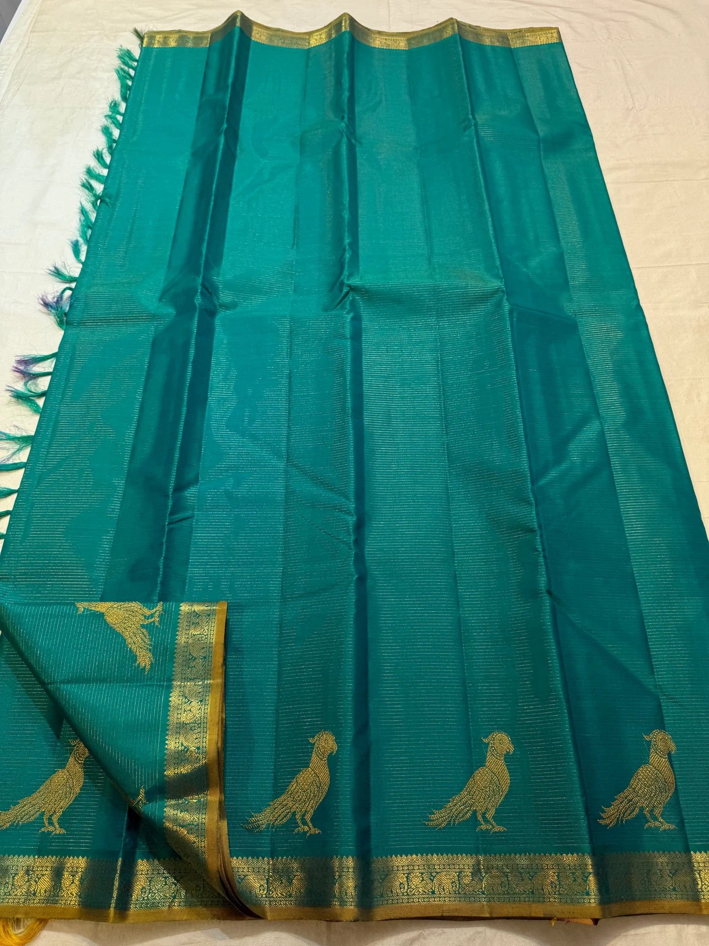 Mayil Kazhuthu Vairaoosi silk saree with continuous parallel gold zari lines and statement bird motifs.