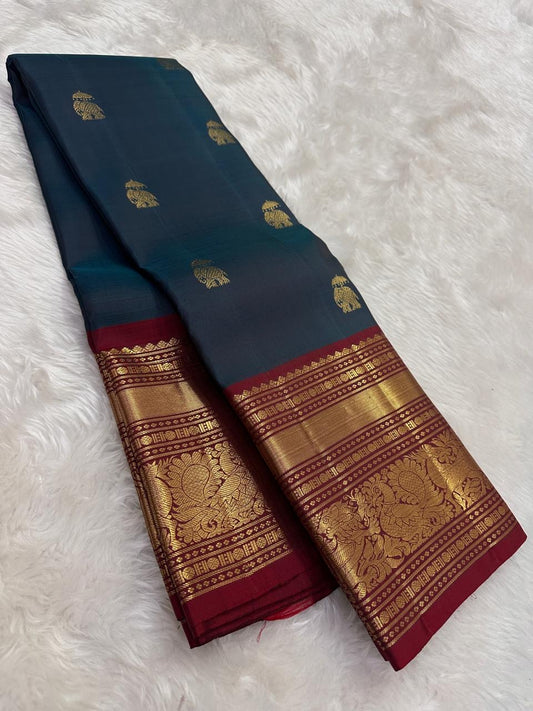 Handwoven peacock blue Kanjeevaram pure silk saree with gold zari Yaanai Ambari Butta and deep red Vanasringaram border