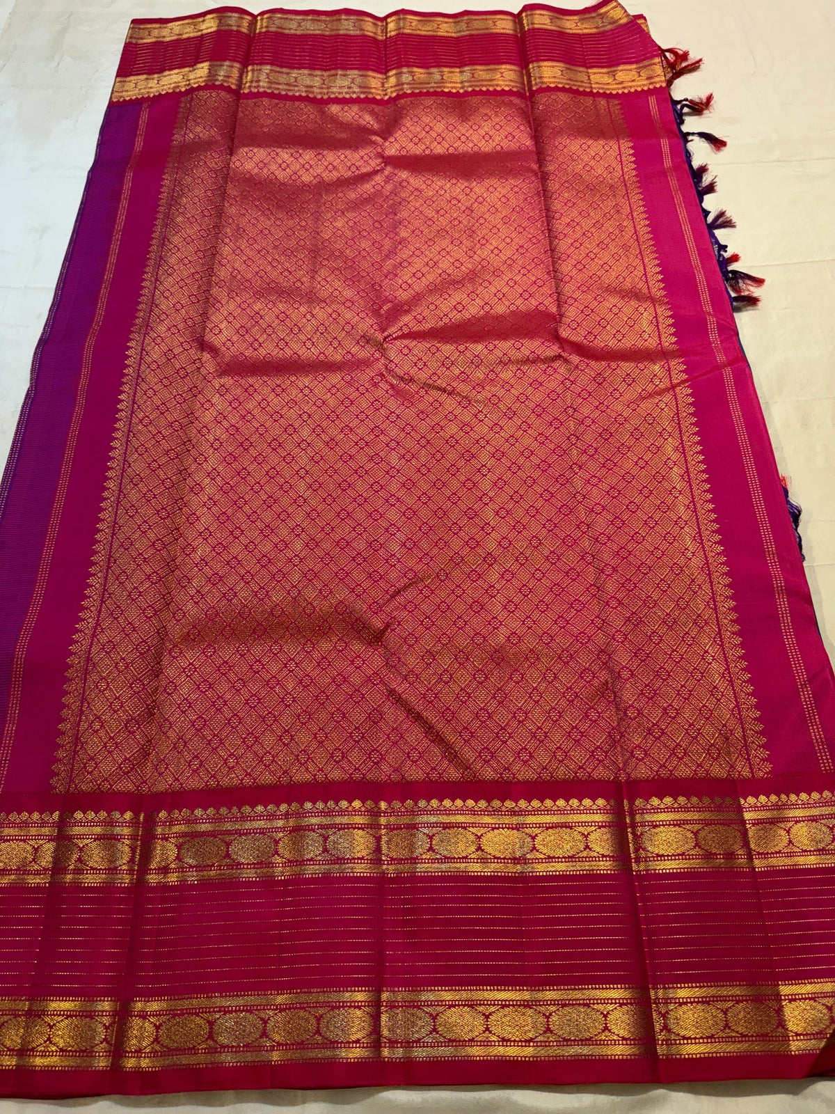 Close view of Mayil and circular Chakram zari buttas across Peacock Blue pure silk saree.