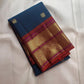Close-up of antique gold zari Butta motifs on peacock blue Kanchipuram silk saree