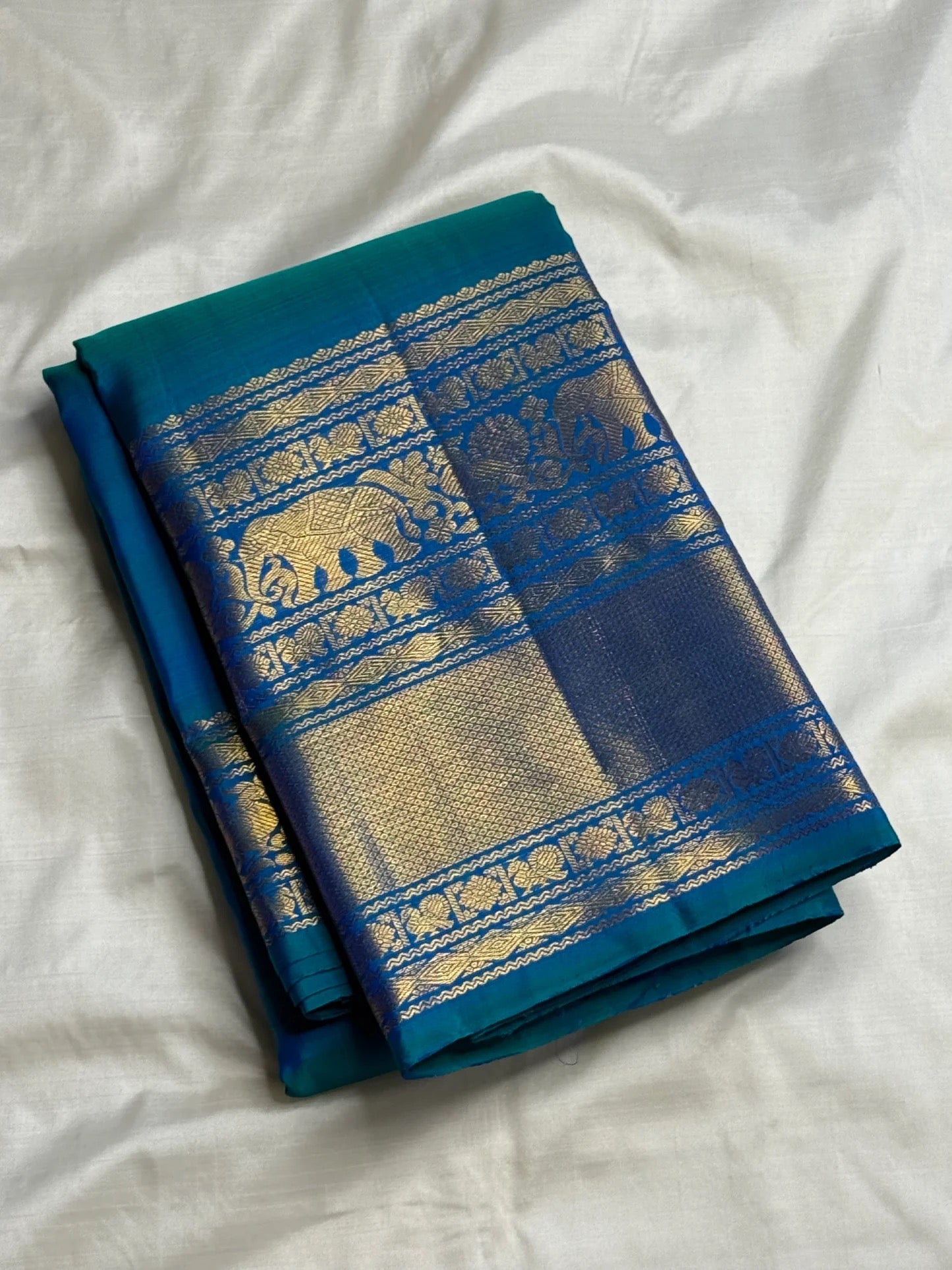 Peacock Blue pure silk Kanjivaram Varisaipet saree with layered gold zari border.