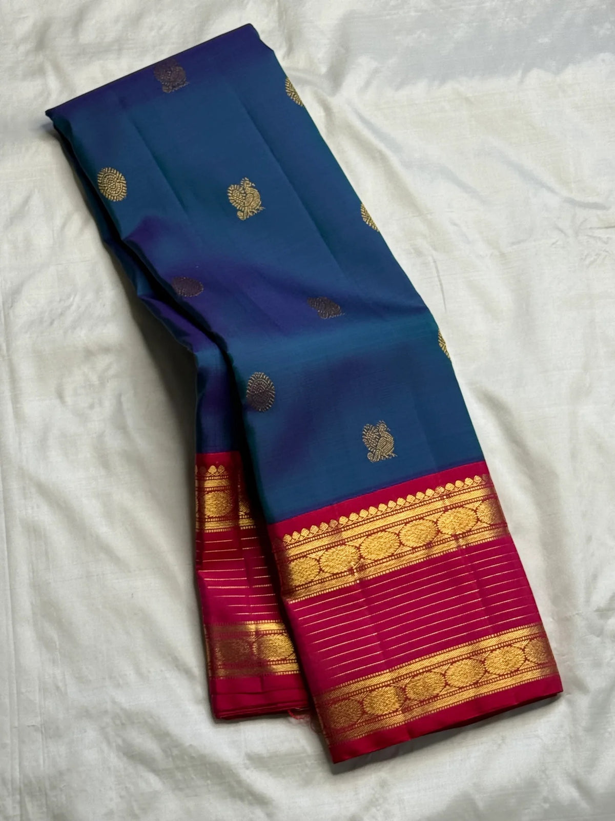 Peacock Blue pure silk Kanchi Pattu Rettapet saree with Rani Pink Korvai gold zari border.