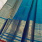 Handwoven pure silk Sapphire Blue saree with repeated small zari buttas and broad gold border.