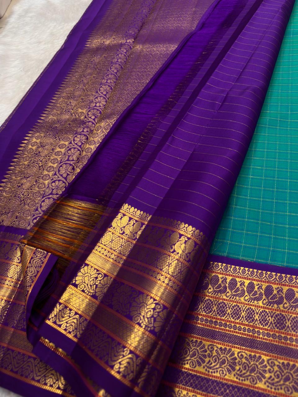 Authentic Kancheepuram Korvai silk saree with emerald teal body and striking purple contrast pallu