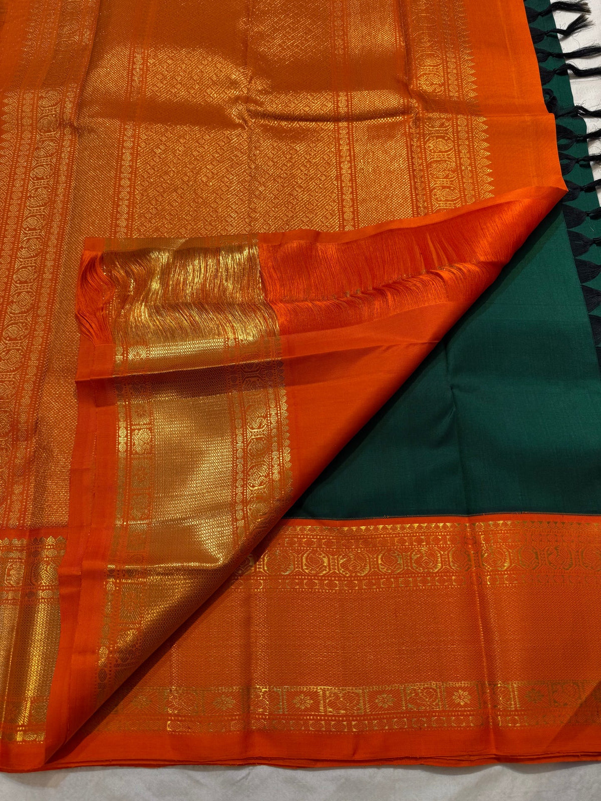 Peacock-eye Mayilkann motif in gold zari border on Kanchipuram saree