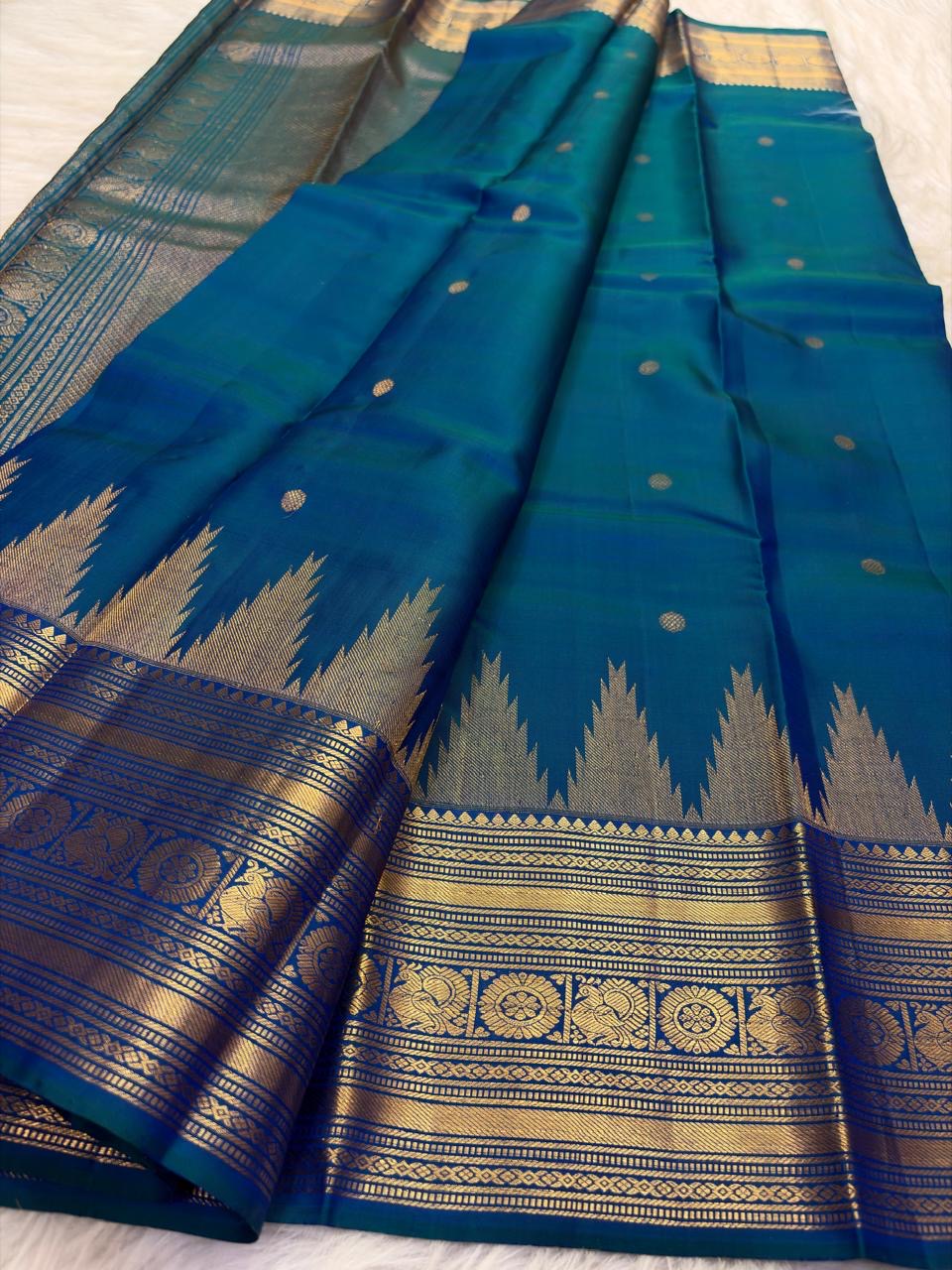 Peacock Blue Thazampoo Reku pure silk Kanchipuram saree, full saree, showing deep oceanic peacock blue with a teal-green glimmer, royal blue border accents and antique-gold zari