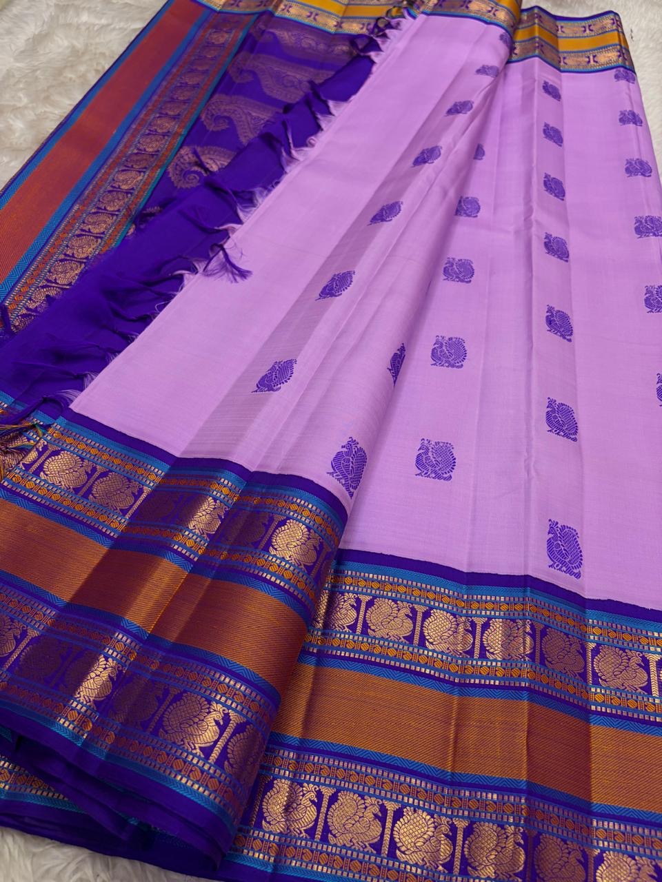 Peacock motif border with zari and turquoise silk thread on lavender Kanjivaram saree, border close up