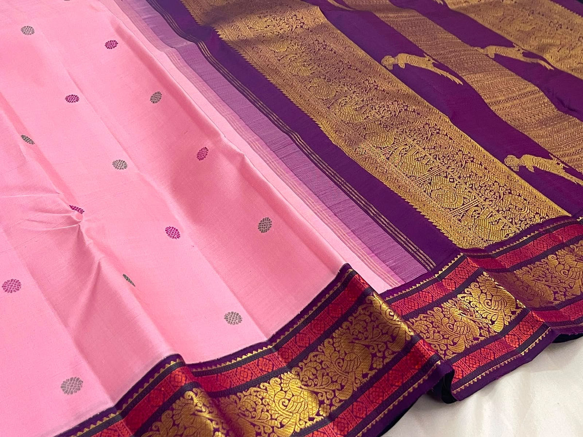Close view of the peacock motif border on lotus pink Pure Silk Kanchipuram