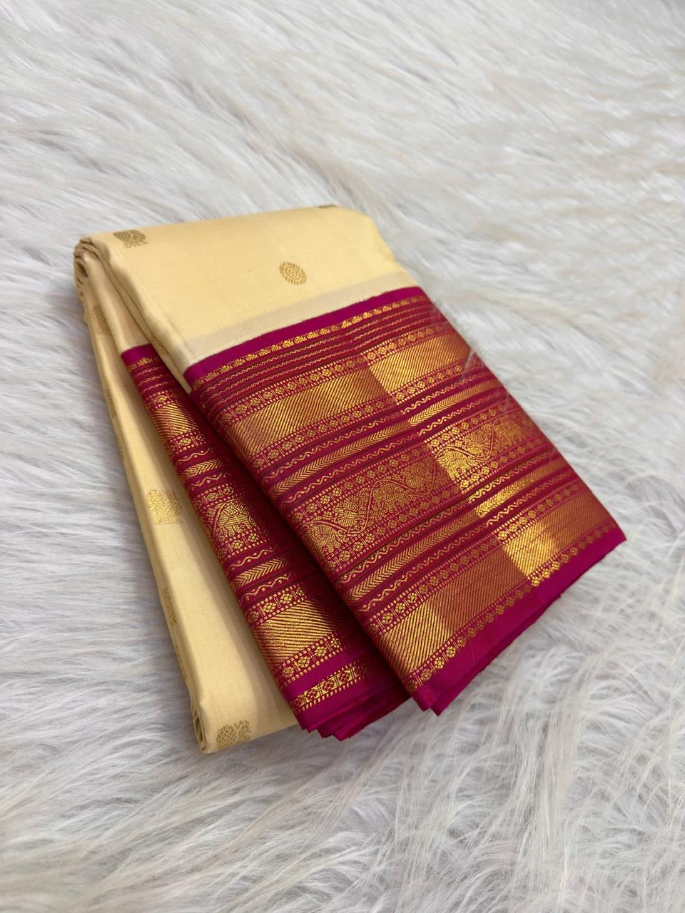Gold zari peacock motifs scattered on the ivory silk body of a Varisaipet Kanjipuram saree