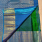 Folded Peacock Neck Blue-Green Pure Silk Kanchipuram Butta saree with Veena-Peacock medallion and geometric gold zari border.