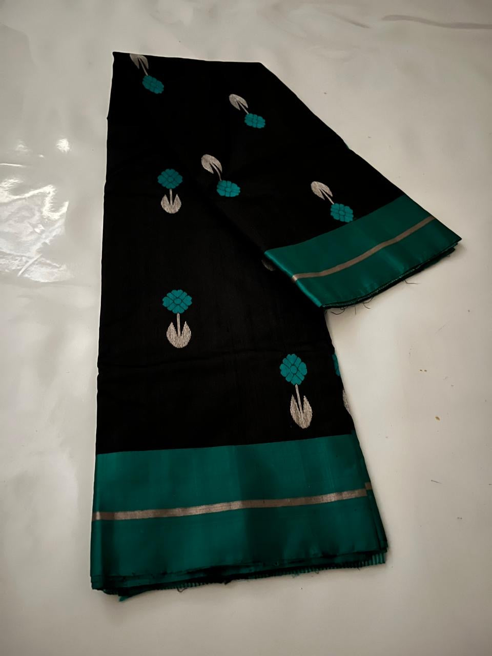 Peacock-teal butta detail on midnight-black Pattu Silk Chanderi saree