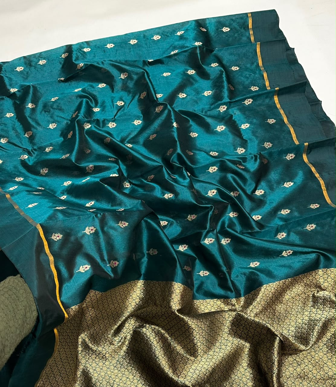 Peacock teal handloom Chanderi saree showing its fluid drape and floral details.