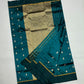Expansive gold patterned pallu on a peacock teal Pattu Silk Chanderi saree.