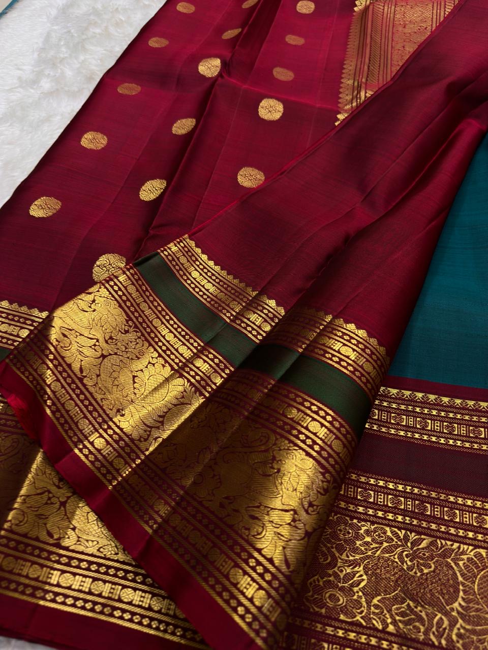 Pure silk teal Butta saree with spaced gold Elephant Ambari motifs across the body