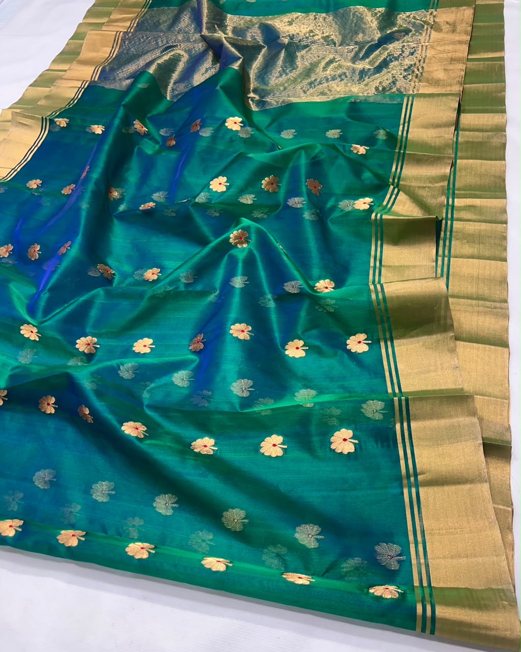 Peacock teal Katan Silk Chanderi saree with gold floral buttas and broad golden borders