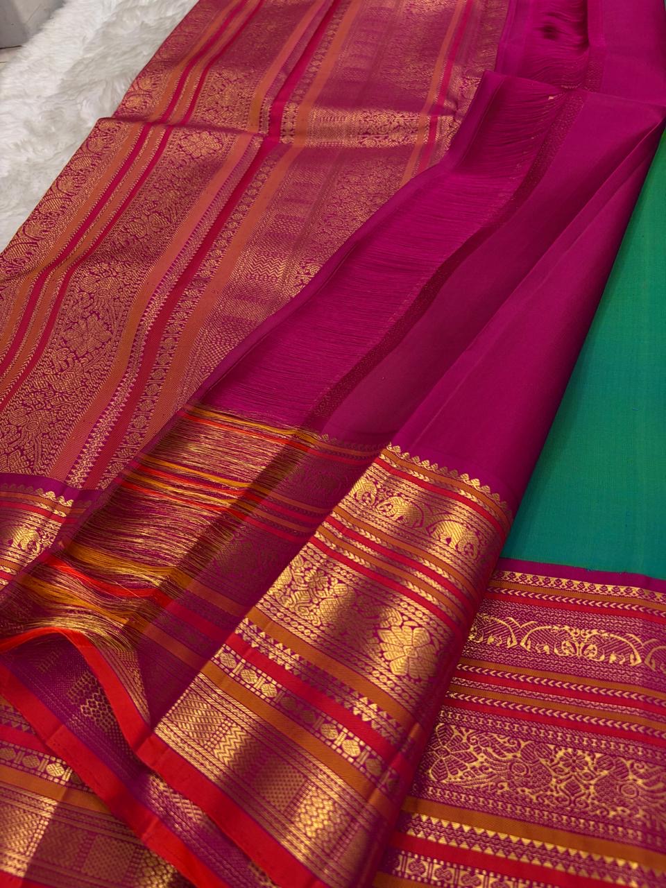 Kanchipattu silk saree in peacock teal with rani pink border Korvai Varisaipet weave traditional zari detail