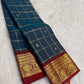 Rich gold zari border against the Deep Peacock Teal pure silk saree.