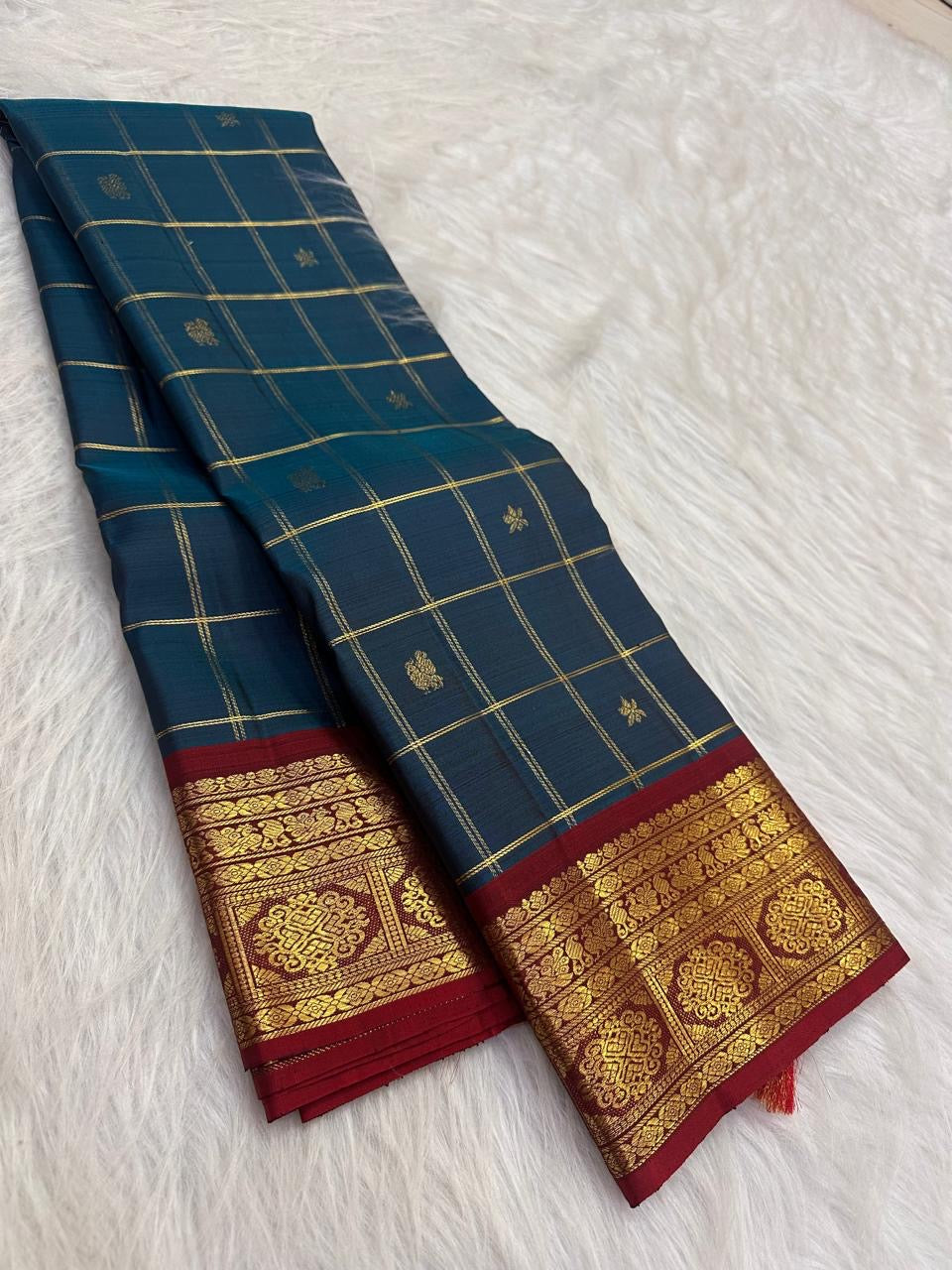 Rich gold zari border against the Deep Peacock Teal pure silk saree.