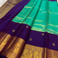 Close-up of kamalam butta in gold zari on peacock teal Kanjeevaram silk saree — Idam Living
