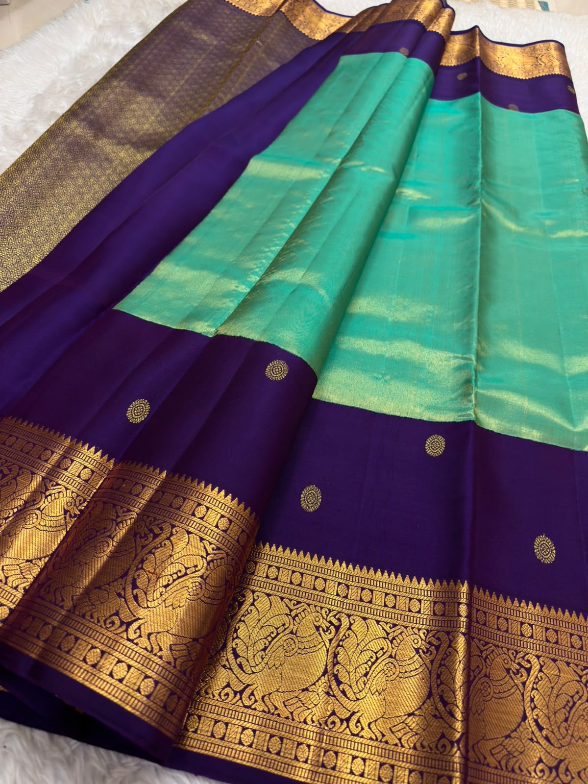 Close-up of kamalam butta in gold zari on peacock teal Kanjeevaram silk saree — Idam Living