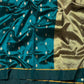 Fine repeated geometric gold weaving on the Chanderi saree pallu.