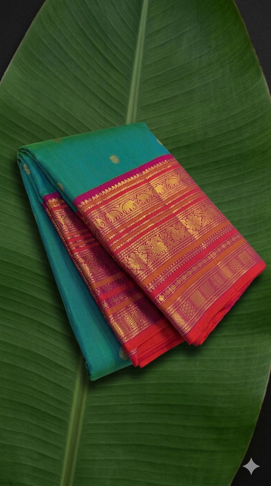 Kanchipuram silk saree in peacock teal with rani pink border Korvai Varisaipet weave folded view
