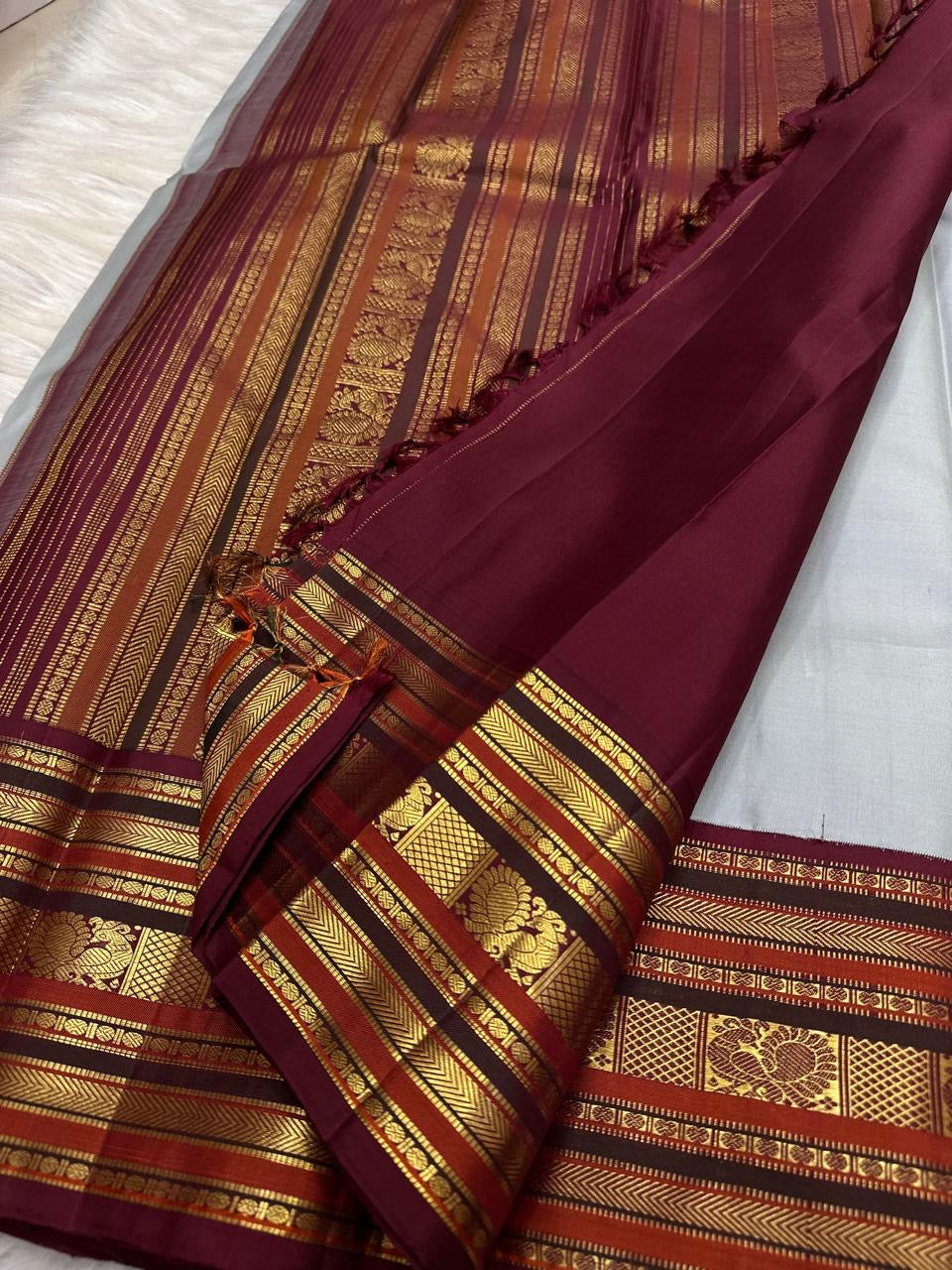 Stacked Varisaipet zari border showing Mayil Kann and Thazhampoo Reku patterns on grey silk