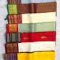 Overlapping folds of grey Kanchipuram silk showing Kalam body buttas and a gold zari border