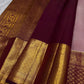 Pearl-ivory Pure Silk Kanchipuram contrasted with vermilion-red border and warm traditional gold zari.