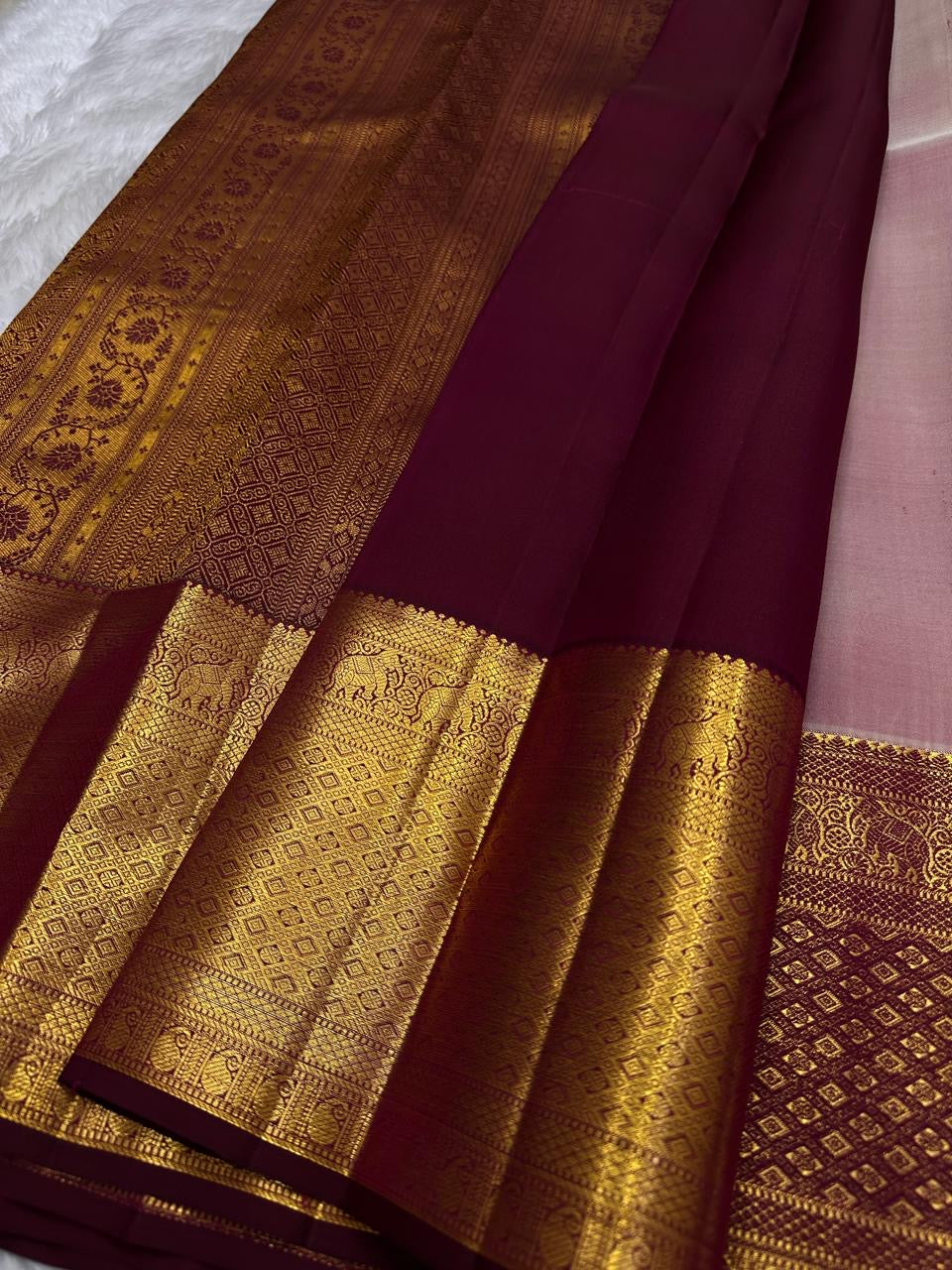 Pearl-ivory Pure Silk Kanchipuram contrasted with vermilion-red border and warm traditional gold zari.