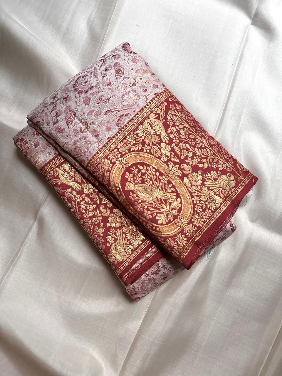 Pearl Ivory Kanchipuram silk saree with all-over floral and foliate woven jaal in muted red and gold.