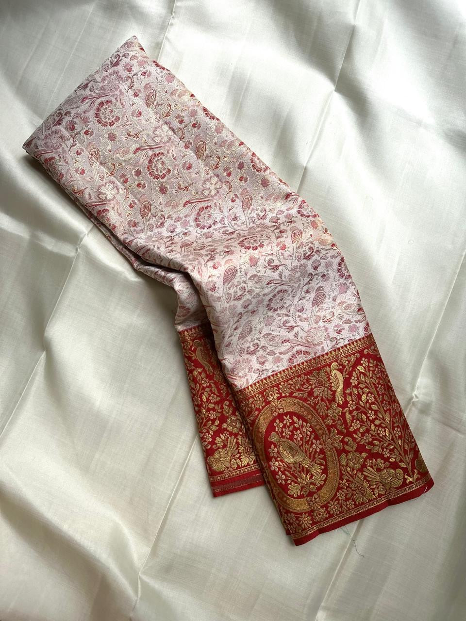 Pearl Ivory and Arakku Red Kanchipuram fusion saree with dense Banarasi-style ornamental zari work.