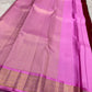Broad rose-gold zari border with floral detailing on a pink silk saree