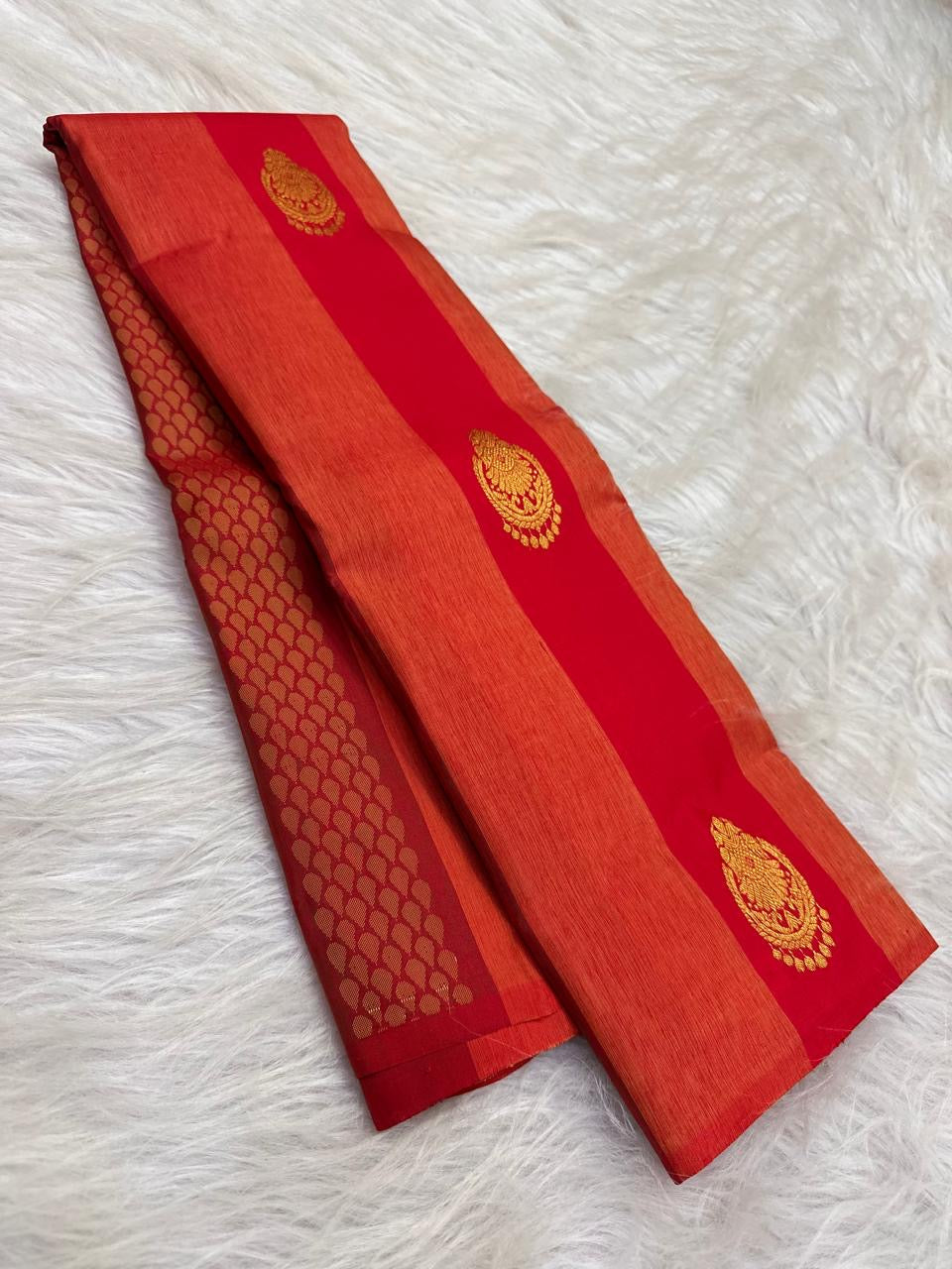 Close view of petite floral zari buttas on vermilion pure silk