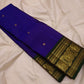 Close view of petite Kamalam and Mayil buttas in gold zari on royal-violet Kanchipuram pure silk.