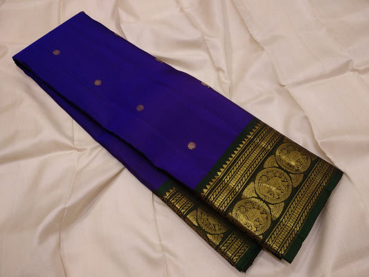 Close view of petite Kamalam and Mayil buttas in gold zari on royal-violet Kanchipuram pure silk.