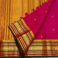 Close view of petite handwoven gold zari buttas on Raspberry Pink silk