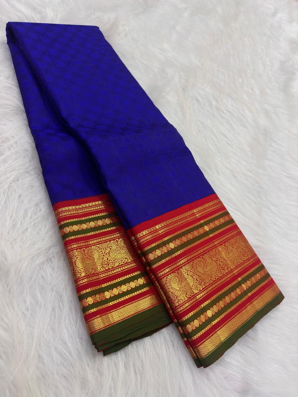 Pillar-box red border close-up, royal-blue Kanchi Pattu Korvai saree