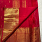 Full Pillar-Box Red Butta saree showing spaced gold motifs and broad gold zari borders.