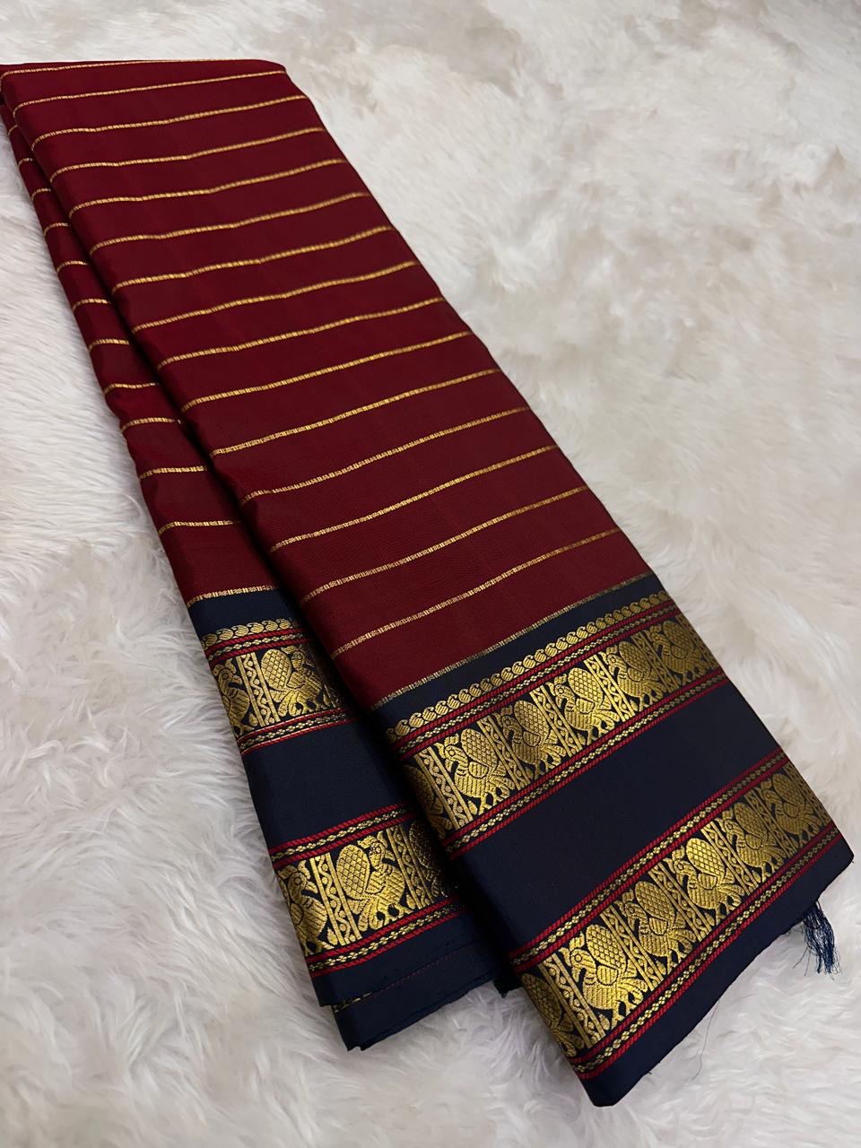 Pillar box red Kanchi Pattu saree with Veldhari stripes and Rettapet border