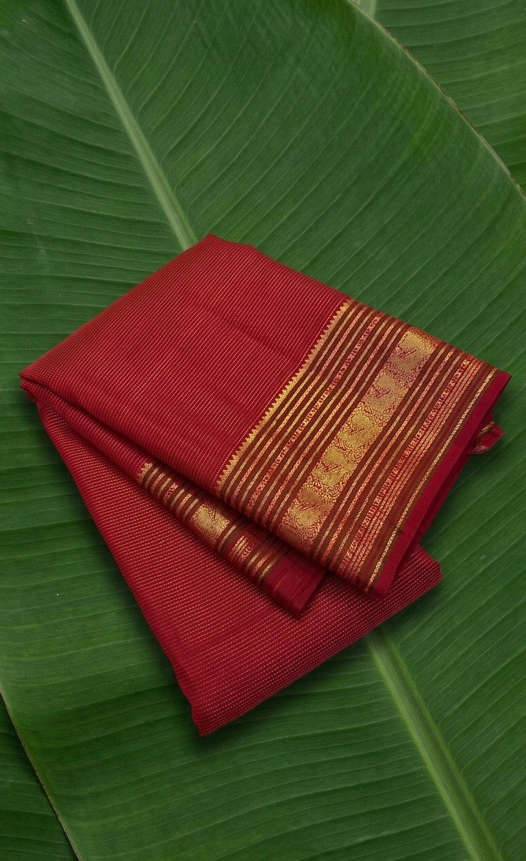 Closeup red Kanchipuram saree varisaipet border and gold zari butta pallu detail Idam Living