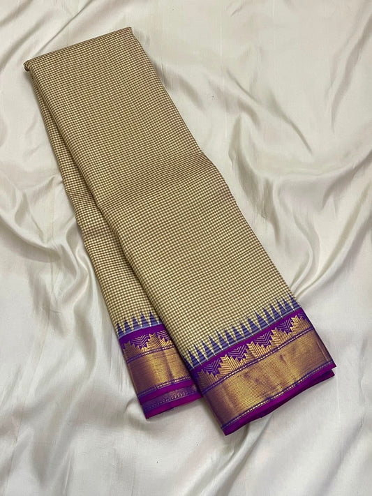 Pillayar Reku zari border detail on the warm ivory taupe Kanchipuram saree