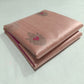 Close-up of the vivid Rani Pink accents within the silver floral buttas on a Blush Peach Chanderi saree