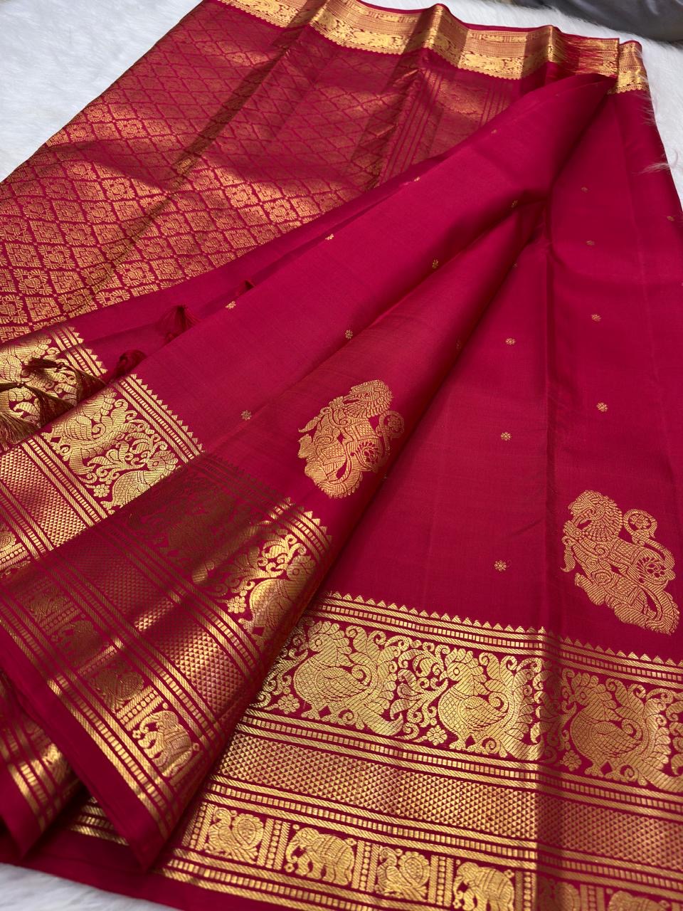Sindoor Red Kanjivaram Butta saree with antique-gold Yazhi motif border.