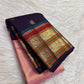 Deep aubergine frame around luminous rose pink tissue saree body