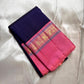 Pink and blue Kanchipuram silk saree folded with gold zari border visible