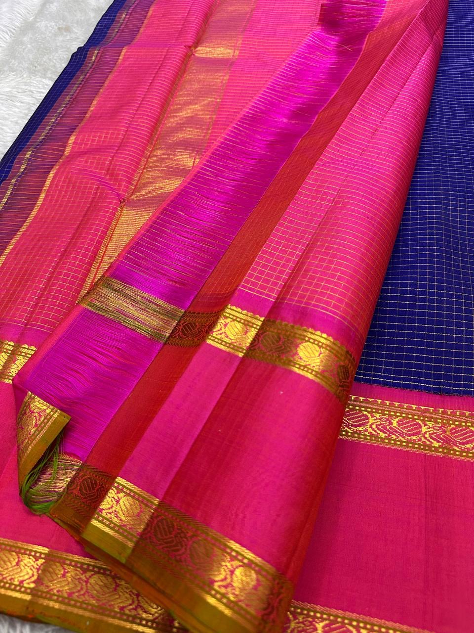 Pure Kanchipuram silk saree pallu spread showing pink zari panels with gold weave and blue checked body, shipped from New Jersey USA